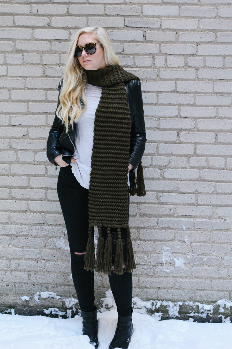 A faux leather jacket, booties, and an oversized scarf for a winter date night outfit