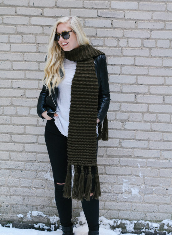 A faux leather jacket, booties, and an oversized scarf for a winter date night outfit