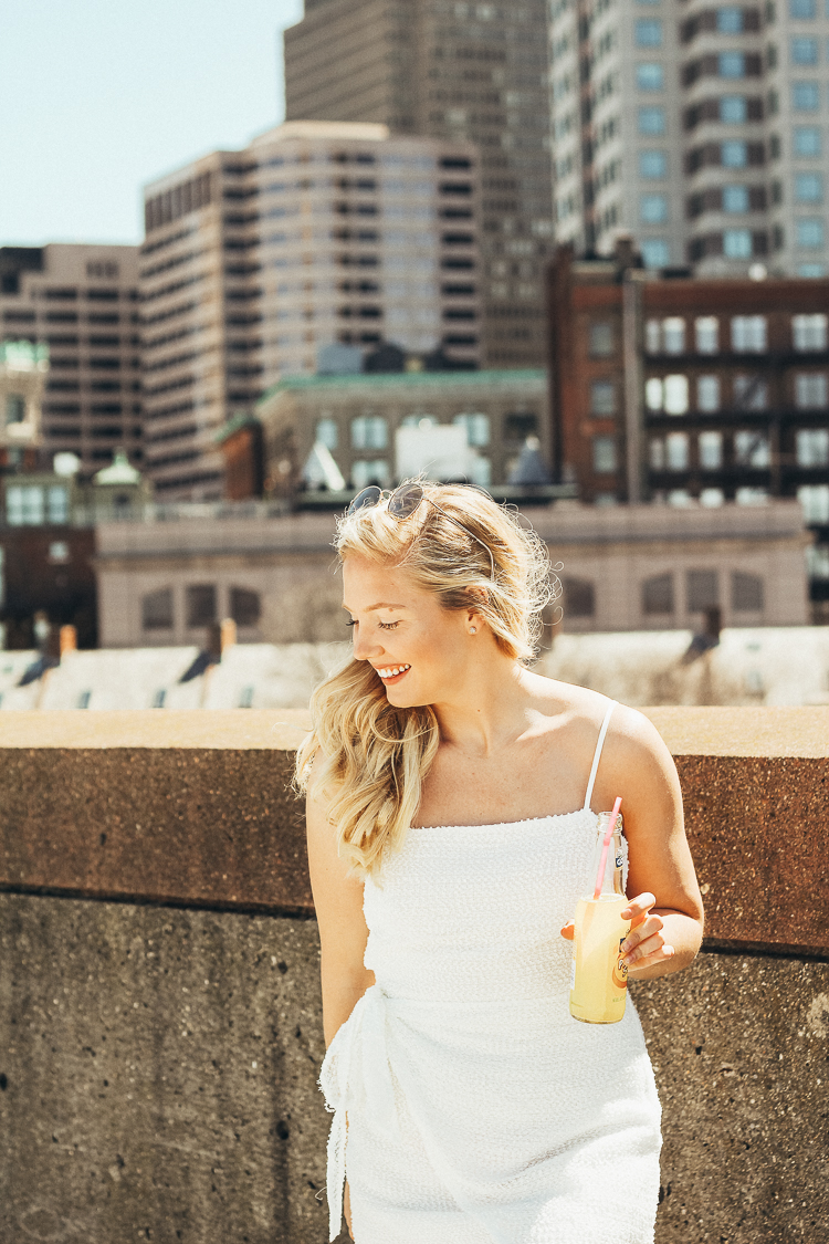 spring outfit in boston | best views of boston | where to go for the best views in Boston | Princess Polly Boutique Dress | White wrap dress for spring | dress with sneakers | parking garage views in Boston | why you should do those things that scare you | do all of the things that scare you | princess polly dresses |