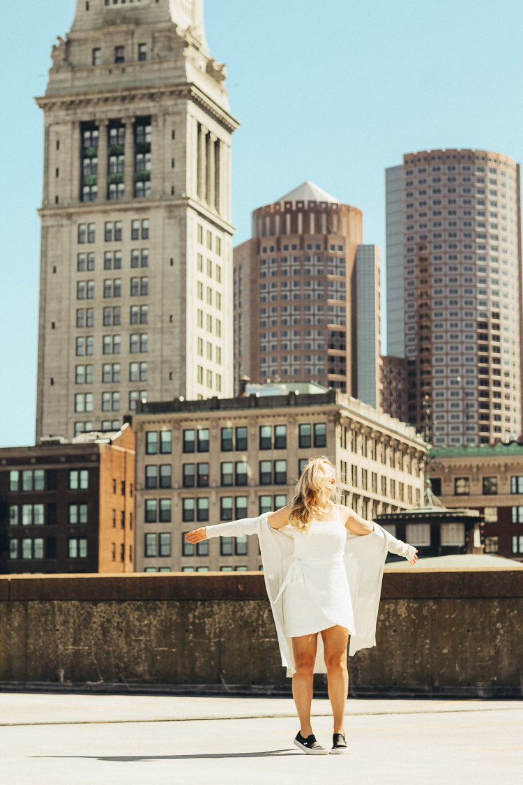 spring outfit in boston | best views of boston | where to go for the best views in Boston | Princess Polly Boutique Dress | White wrap dress for spring | dress with sneakers | parking garage views in Boston | why you should do those things that scare you | do all of the things that scare you | princess polly dresses | 